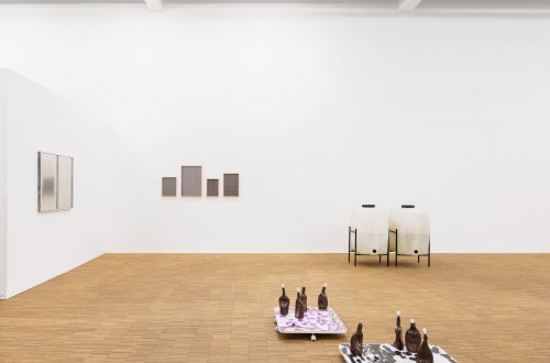Blick in die Ausstellung „vakuum“ mit Arbeiten von Francisco Valença Vaz und Martin Sommer: deformierte Tonflaschen auf bunten Platten, dahinter zwei Lithiumbehälter vor weißer Wand