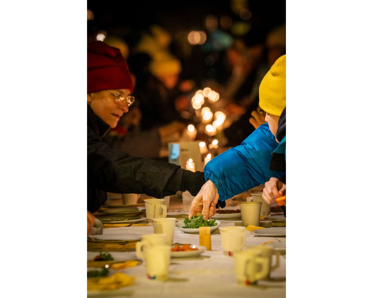 People sharing warm food outdoors at Frostgarten during the minus20degree biennale in Flachau