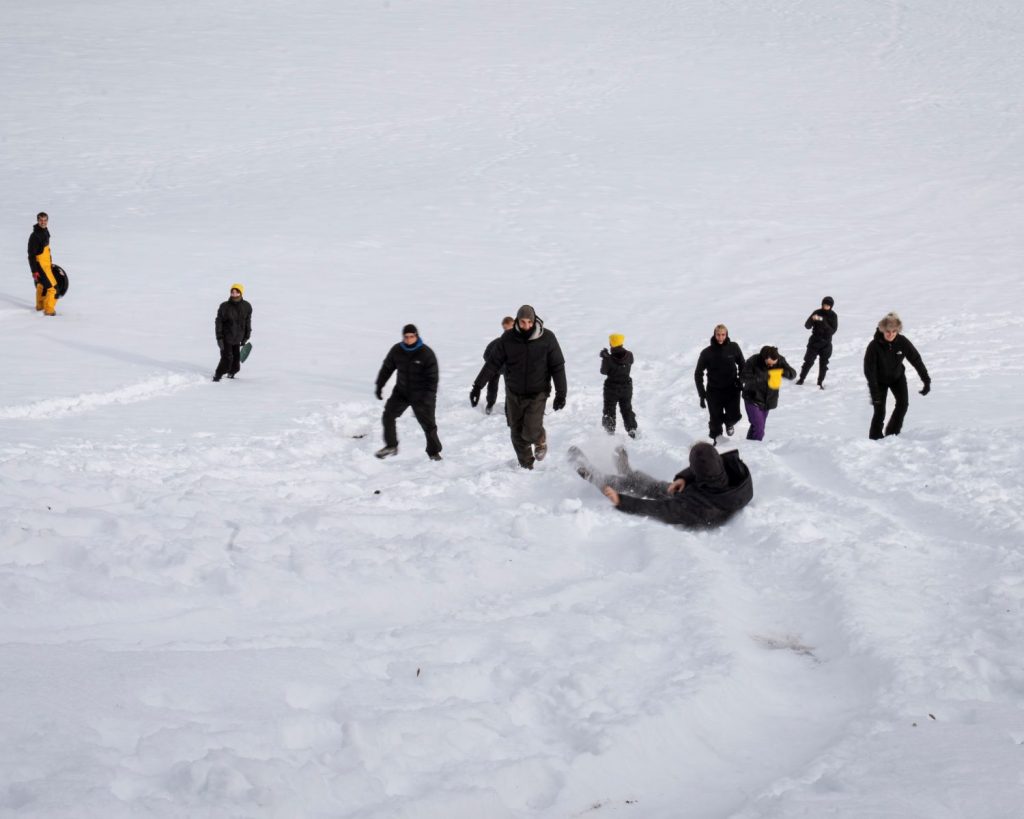 People sliding down a snowy slope during Gemeinschaftliches Fallen at minus20degree biennale