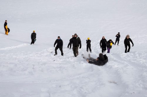 People sliding down a snowy slope during Gemeinschaftliches Fallen at minus20degree biennale